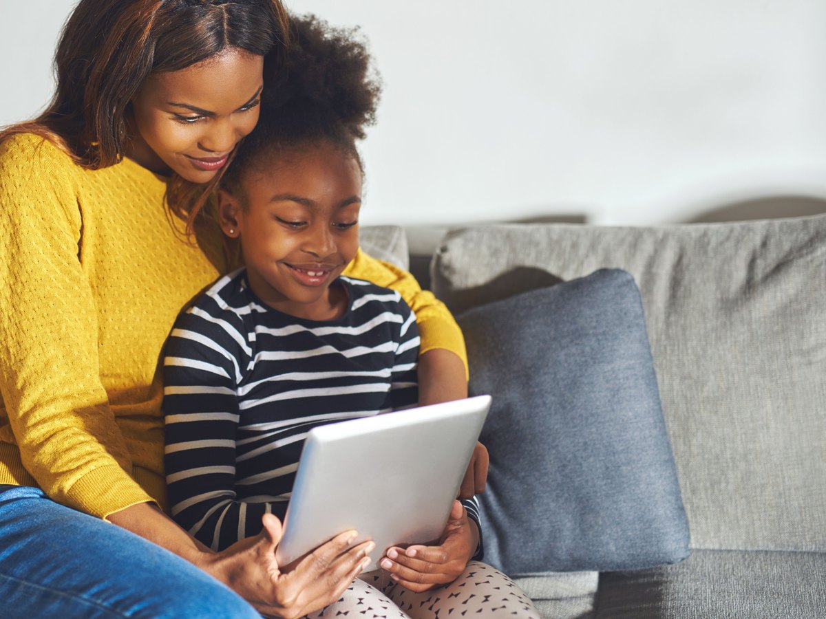 A parent and child learning together at home